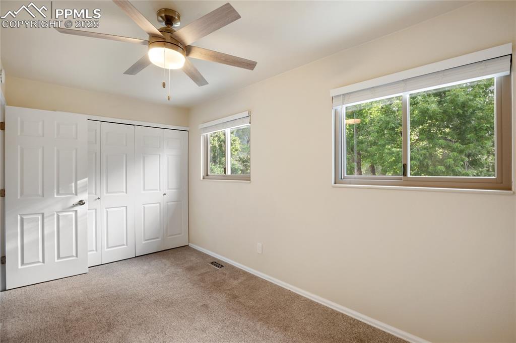 3004 Springlake Circle East Colorado Springs, CO 80906 - Photo 31 of 50 an empty room with windows and fan