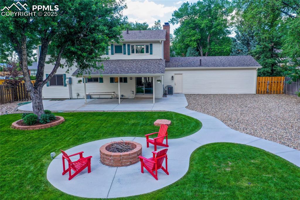 3004 Springlake Circle East Colorado Springs, CO 80906 - Photo 45 of 50 a view of a house with a yard patio and fire pit