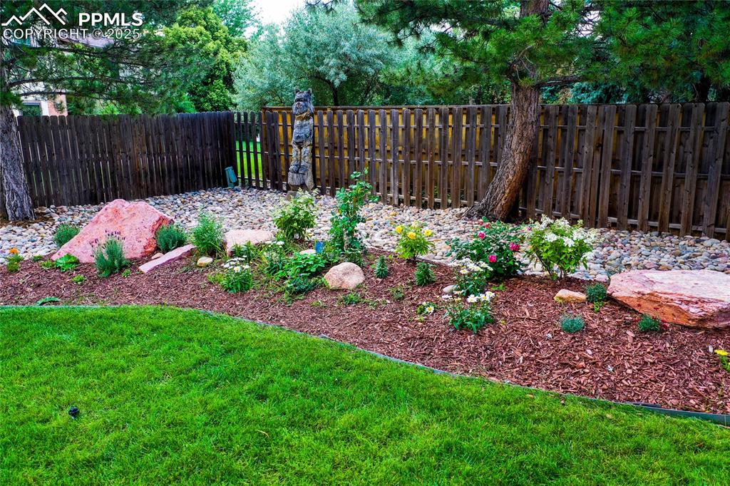 3004 Springlake Circle East Colorado Springs, CO 80906 - Photo 48 of 50 a garden with plants and wooden fence