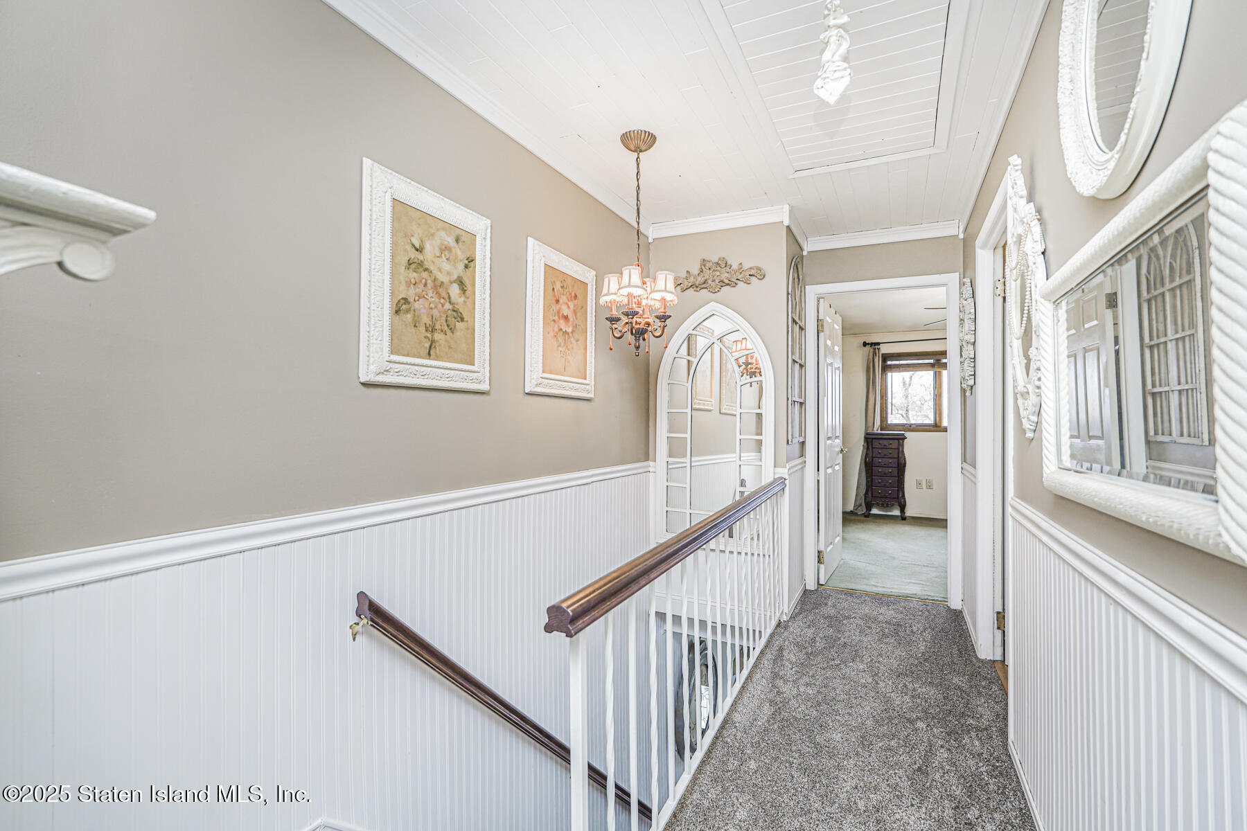 197 Crossfield Avenue Staten Island, NY 10312 - Photo 11 of 28 a view of staircase with lots of frames on wall and a large window