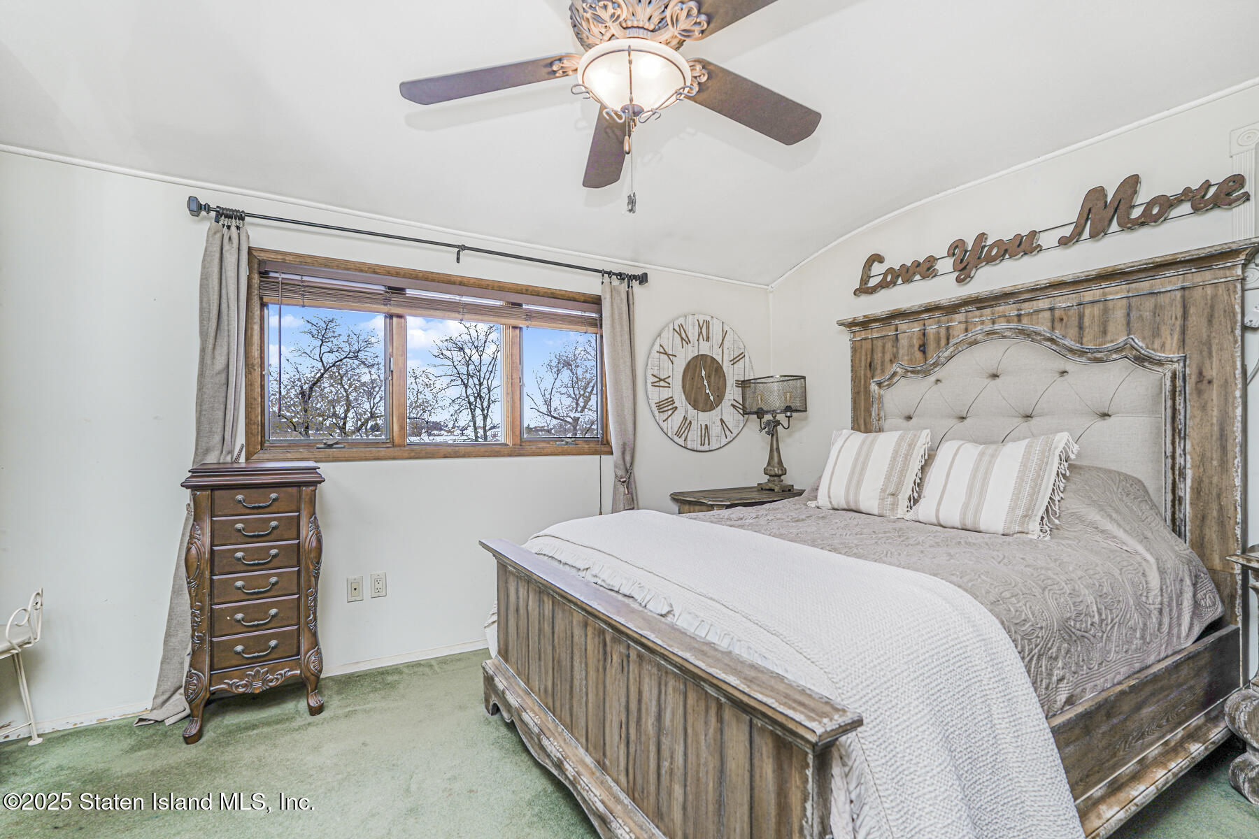 197 Crossfield Avenue Staten Island, NY 10312 - Photo 12 of 28 a bedroom with a bed a window and a chandelier