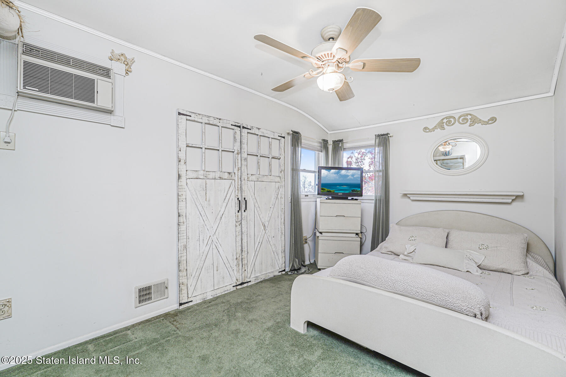 197 Crossfield Avenue Staten Island, NY 10312 - Photo 14 of 28 a bedroom with a large bed and a chandelier