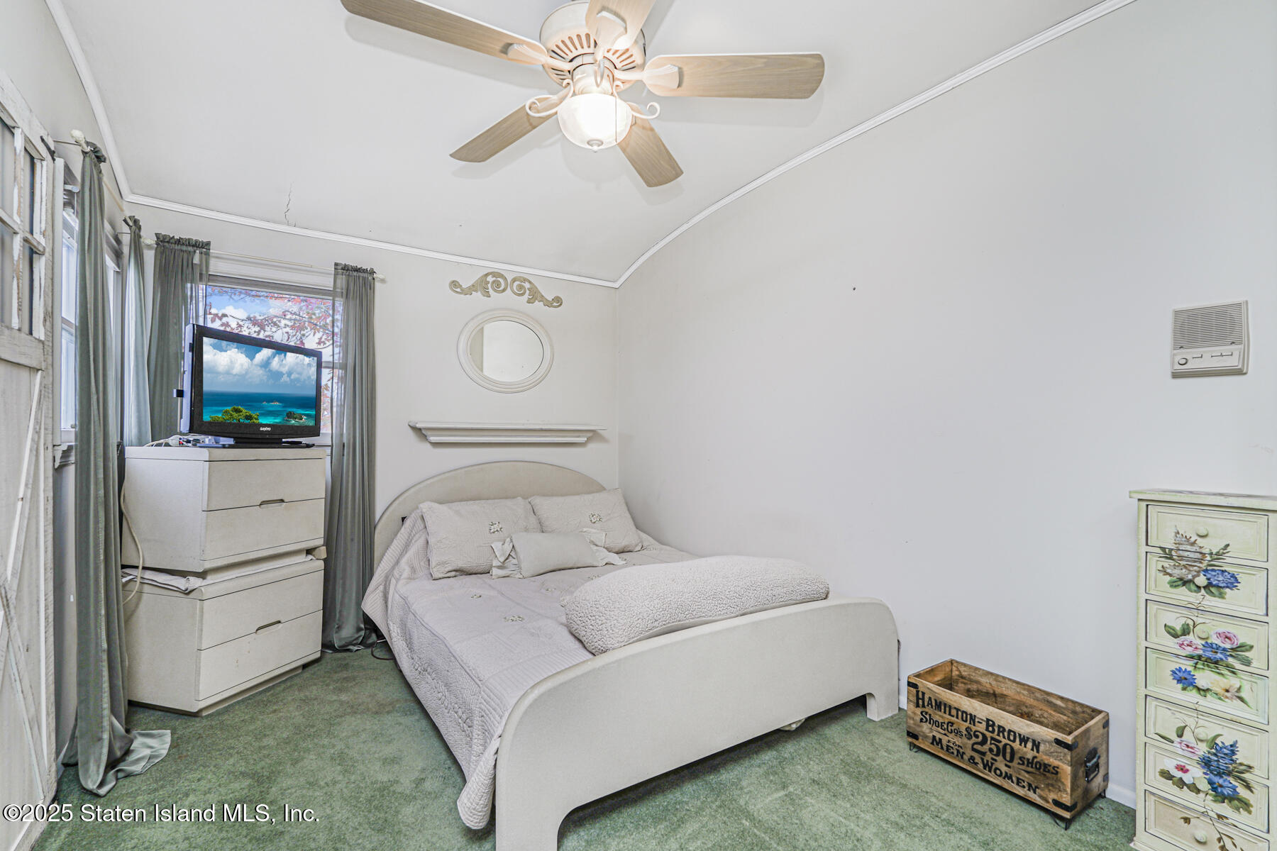 197 Crossfield Avenue Staten Island, NY 10312 - Photo 15 of 28 a bedroom with a bed and a chandelier