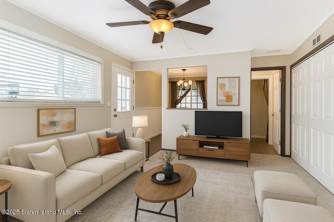 197 Crossfield Avenue Staten Island, NY 10312 - Photo 17 of 28 a living room with furniture a ceiling fan and a window