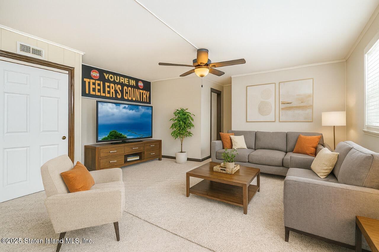 197 Crossfield Avenue Staten Island, NY 10312 - Photo 18 of 28 a living room with furniture a flat screen tv and a window