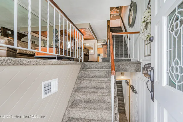 a living room with furniture a clock and a table