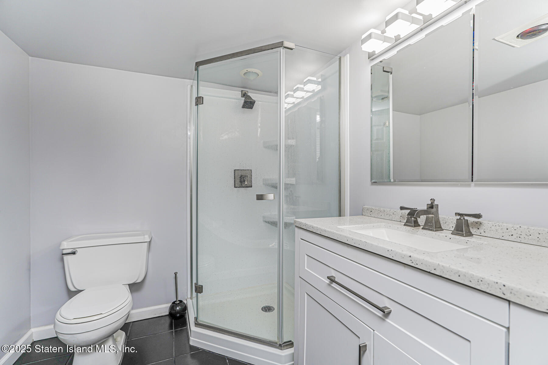197 Crossfield Avenue Staten Island, NY 10312 - Photo 25 of 28 a bathroom with a granite countertop sink toilet and shower