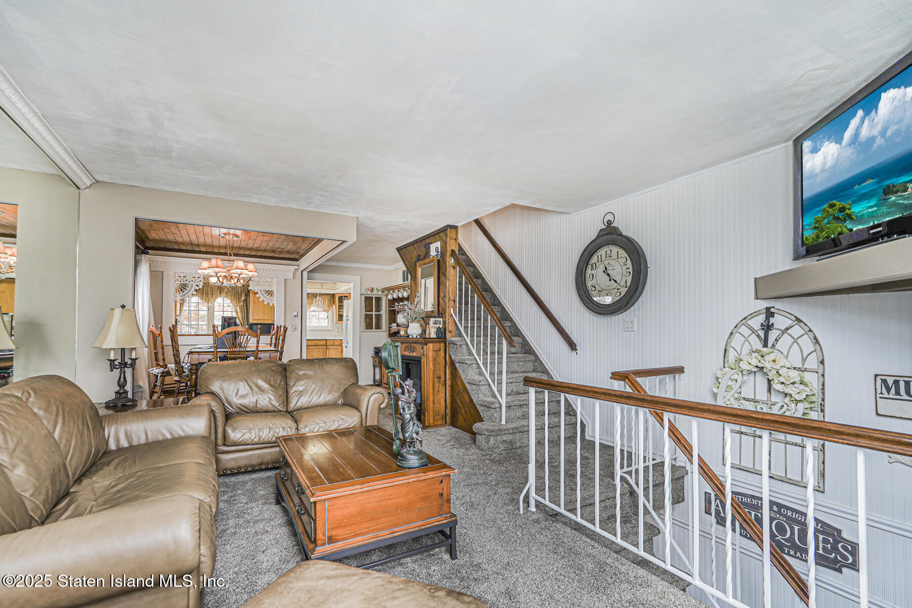 197 Crossfield Avenue Staten Island, NY 10312 - Photo 4 of 28 a living room with furniture and a clock