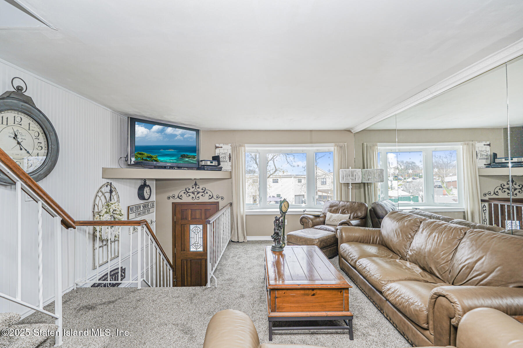 197 Crossfield Avenue Staten Island, NY 10312 - Photo 5 of 28 a living room with furniture a flat screen tv and a fireplace
