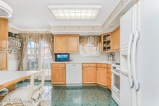 a kitchen with stainless steel appliances a stove a sink dishwasher and cabinets with wooden floor