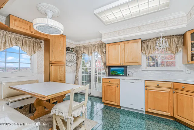 a kitchen with stainless steel appliances a stove a sink dishwasher and a refrigerator with wooden floor