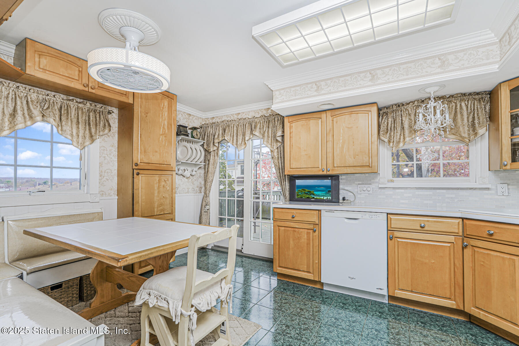 197 Crossfield Avenue Staten Island, NY 10312 - Photo 7 of 28 a kitchen with stainless steel appliances a stove a sink dishwasher and cabinets with wooden floor