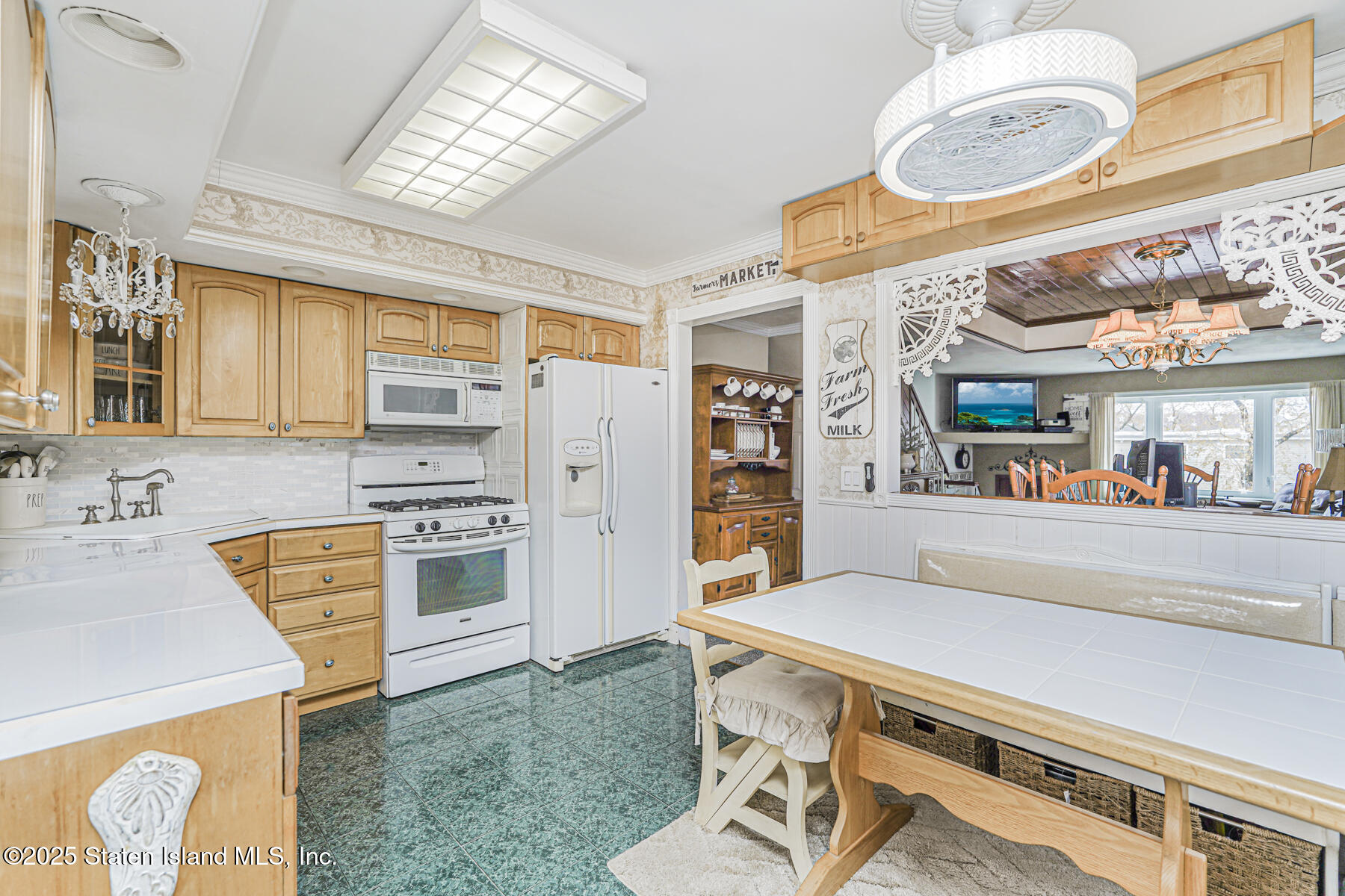 197 Crossfield Avenue Staten Island, NY 10312 - Photo 8 of 28 a kitchen with stainless steel appliances a stove a sink dishwasher and a refrigerator with wooden floor
