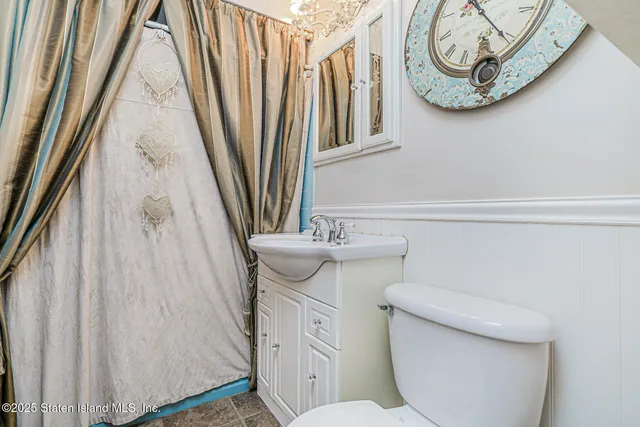 a view of staircase with lots of frames on wall and a large window