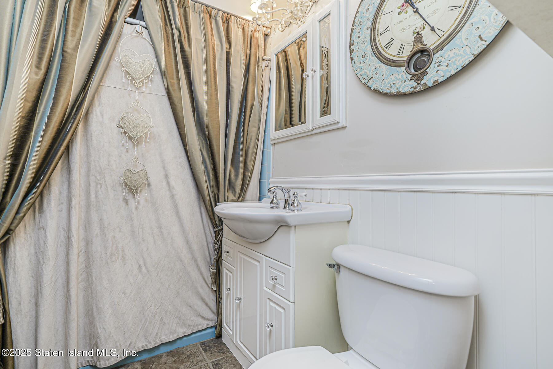 197 Crossfield Avenue Staten Island, NY 10312 - Photo 10 of 28 a bathroom with a toilet a sink and a mirror