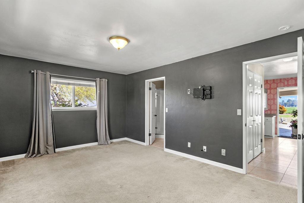 4930 South Faith Home Road Turlock, CA 95380 - Photo 22 of 69 empty room featuring light colored carpet and light tile patterned floors