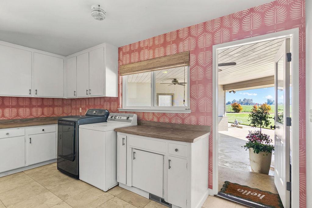 4930 South Faith Home Road Turlock, CA 95380 - Photo 23 of 69 laundry room featuring wallpapered walls, plenty of natural light, with ample cabinet space.