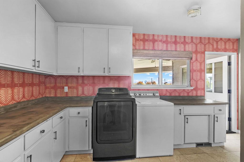 4930 South Faith Home Road Turlock, CA 95380 - Photo 24 of 69 laundry room featuring wallpapered walls, cabinet space