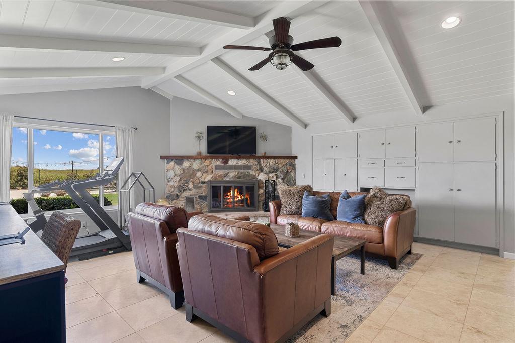 4930 South Faith Home Road Turlock, CA 95380 - Photo 29 of 69 living room with a stone fireplace, recessed lighting, a ceiling fan, light tile patterned flooring, and beamed ceiling