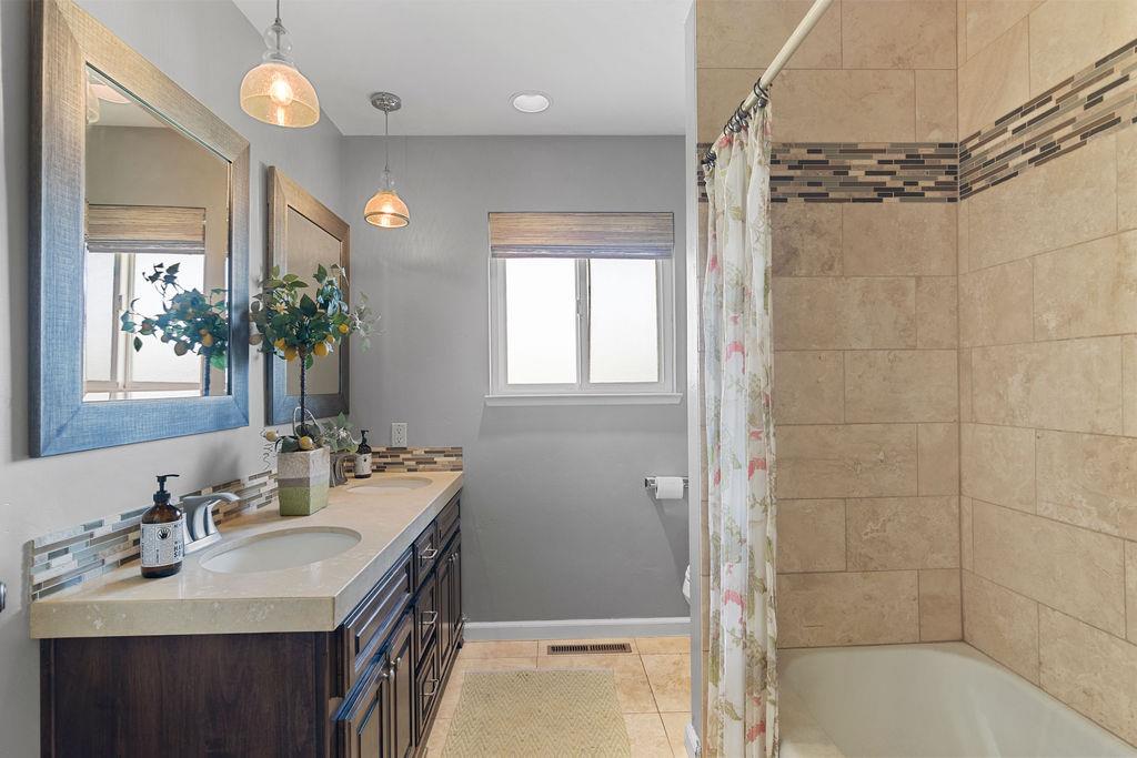 4930 South Faith Home Road Turlock, CA 95380 - Photo 36 of 69 full bathroom with double vanity, shower / tub combo, and light travertine floors