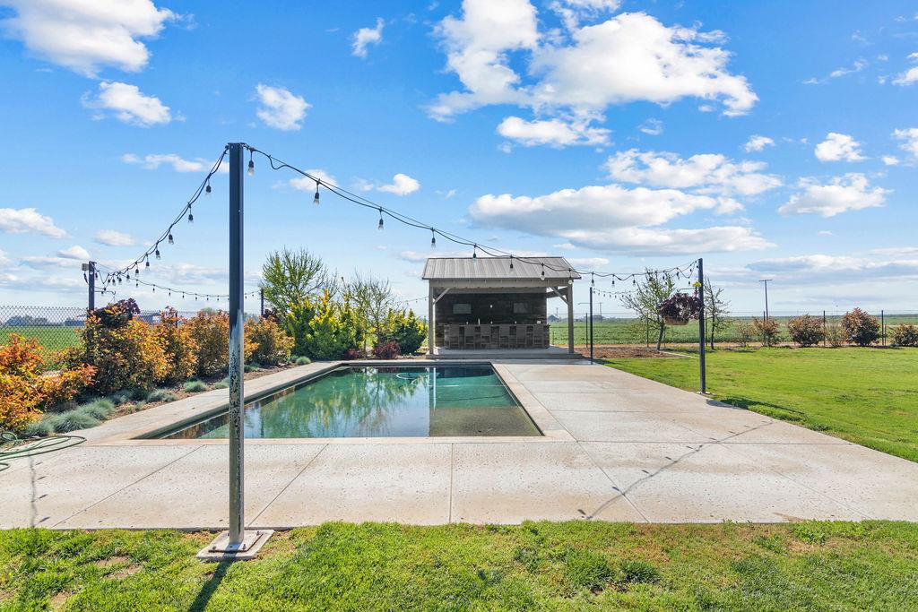 4930 South Faith Home Road Turlock, CA 95380 - Photo 44 of 69 outdoor pool featuring a lawn and a patio