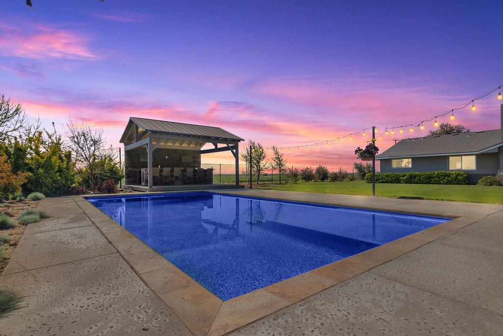 4930 South Faith Home Road Turlock, CA 95380 - Photo 46 of 69 pool at dusk featuring an outdoor pool, a yard, and a patio area