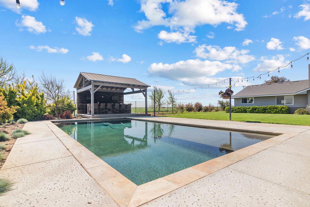 4930 South Faith Home Road Turlock, CA 95380 - Photo 47 of 69 swimming pool featuring a lawn and a patio area