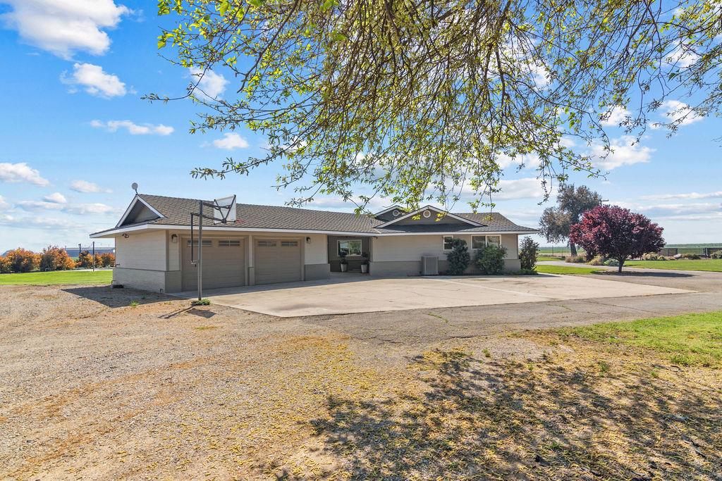 4930 South Faith Home Road Turlock, CA 95380 - Photo 60 of 69 view of front of home with an attached garage and concrete driveway