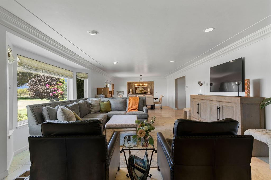 4930 South Faith Home Road Turlock, CA 95380 - Photo 6 of 69 Open Living room area featuring ornamental molding with a formal dining area.