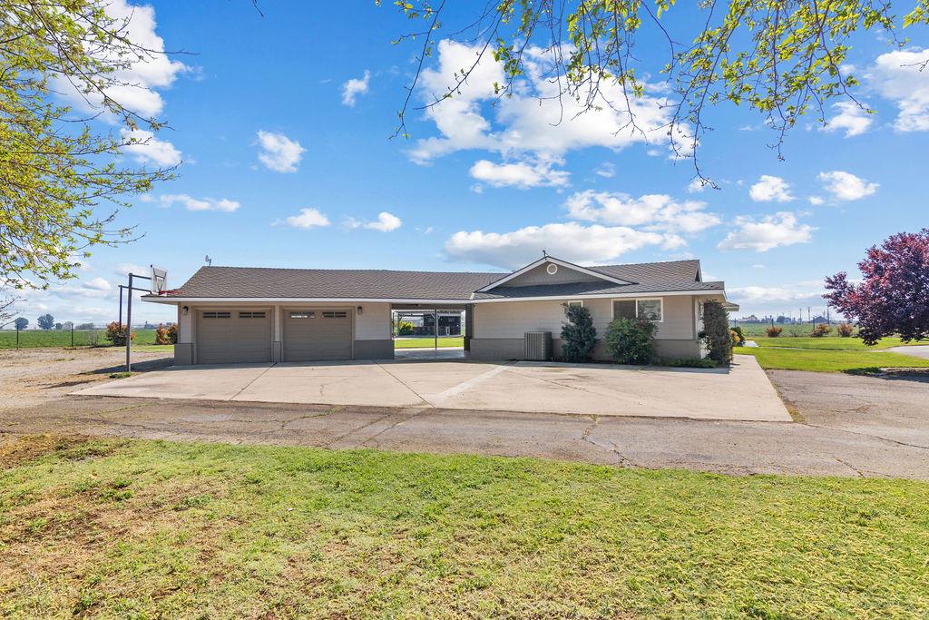4930 South Faith Home Road Turlock, CA 95380 - Photo 61 of 69 single story home with an attached garage, a front yard, and driveway