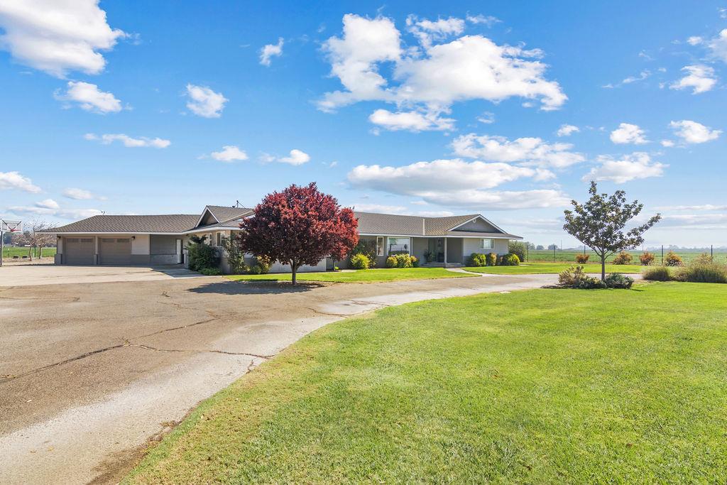 4930 South Faith Home Road Turlock, CA 95380 - Photo 62 of 69 view of front facade with concrete driveway, a garage, and a front yard
