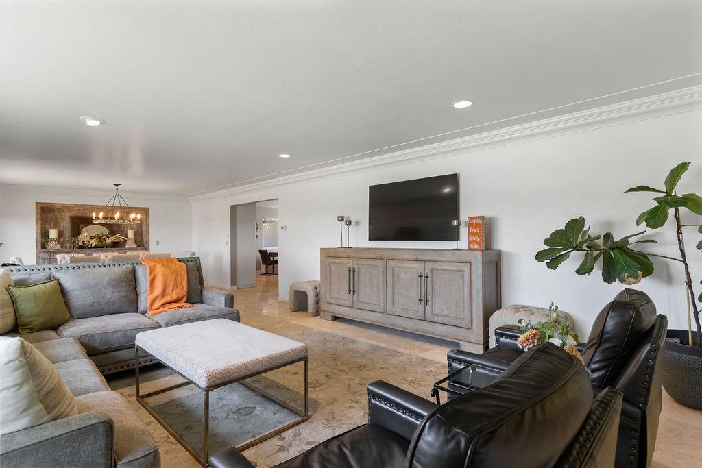 4930 South Faith Home Road Turlock, CA 95380 - Photo 7 of 69 living room featuring crown molding and a chandelier