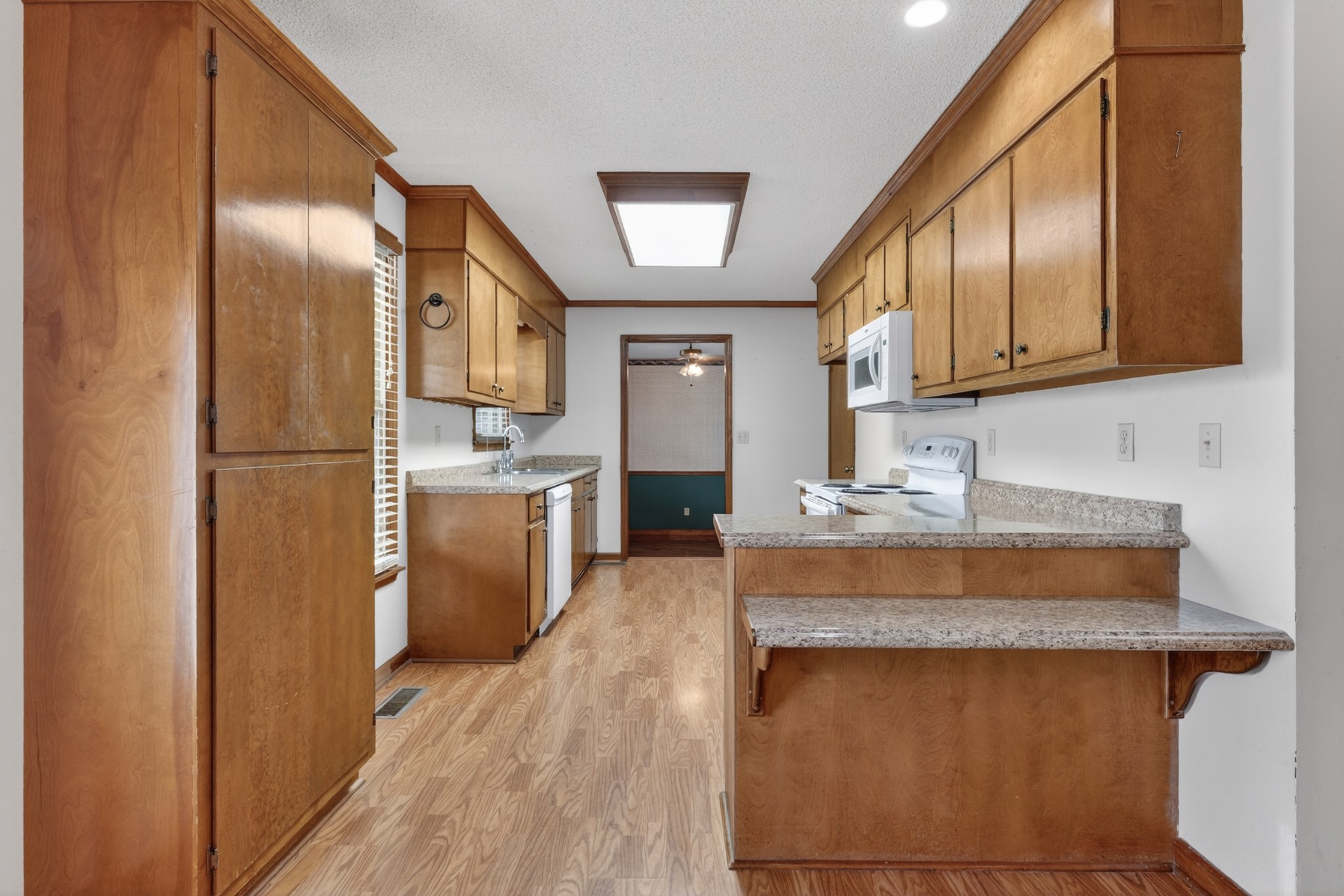 679 Howell Hill Road Flintville, TN 37335 - Photo 11 of 44 a kitchen with stainless steel appliances granite countertop a refrigerator a sink dishwasher a stove with wooden cabinets
