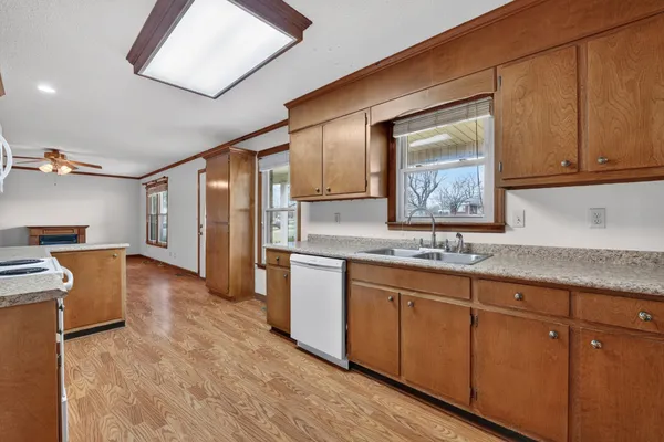 a hallway with sink and wooden floor