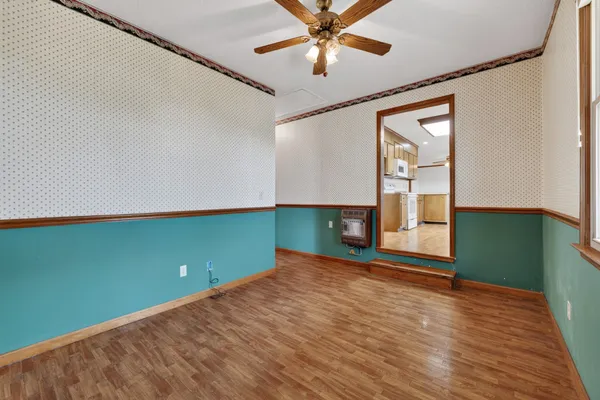 a view of a room with window and wooden floor