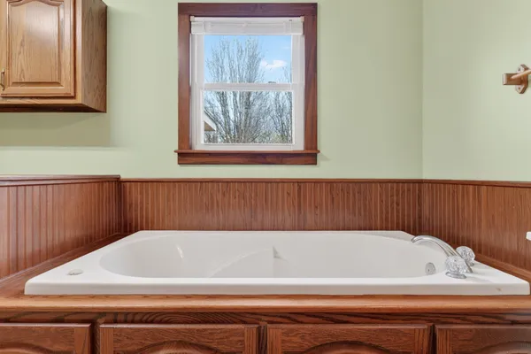 a bathroom with a sink a mirror and a bathtub