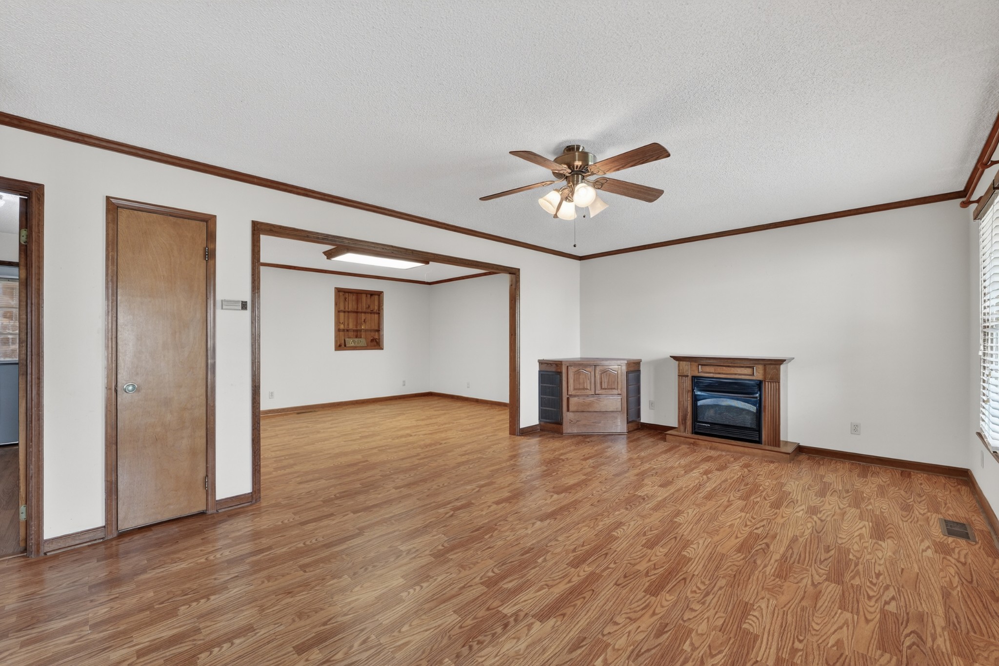 679 Howell Hill Road Flintville, TN 37335 - Photo 8 of 44 a view of an empty room with a window and wooden floor