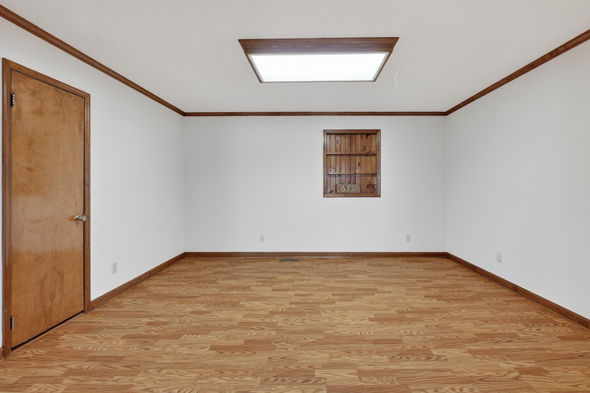 679 Howell Hill Road Flintville, TN 37335 - Photo 10 of 44 a view of an empty room with wooden floor and a window