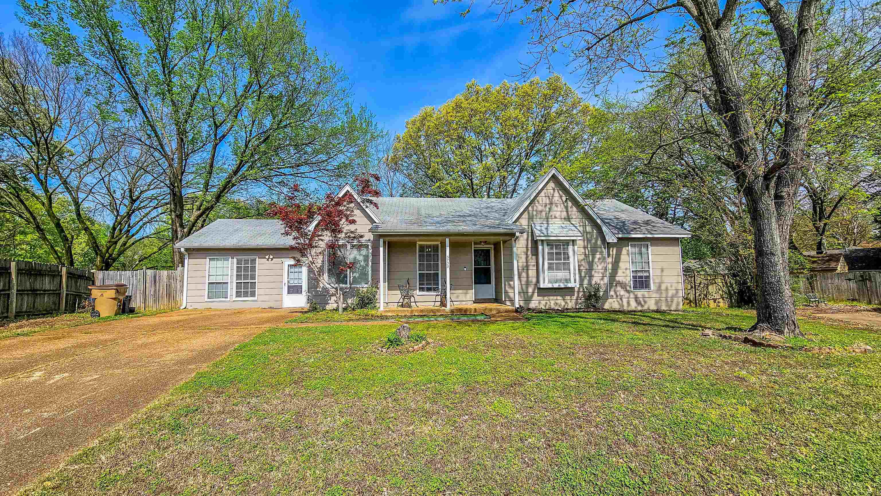 3735 Rippling Creek Cove Memphis, TN 38135 - Photo 2 of 28 a front view of a house with a yard and trees