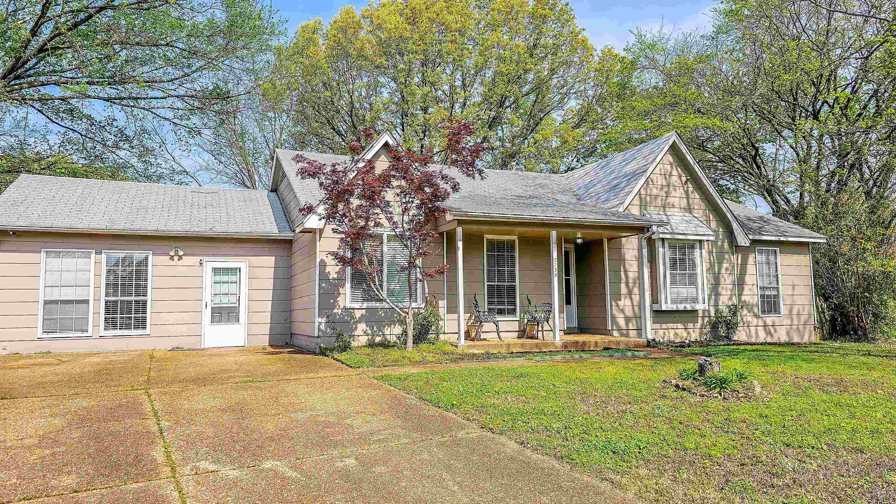 3735 Rippling Creek Cove Memphis, TN 38135 - Photo 3 of 28 a front view of a house with a garden and trees