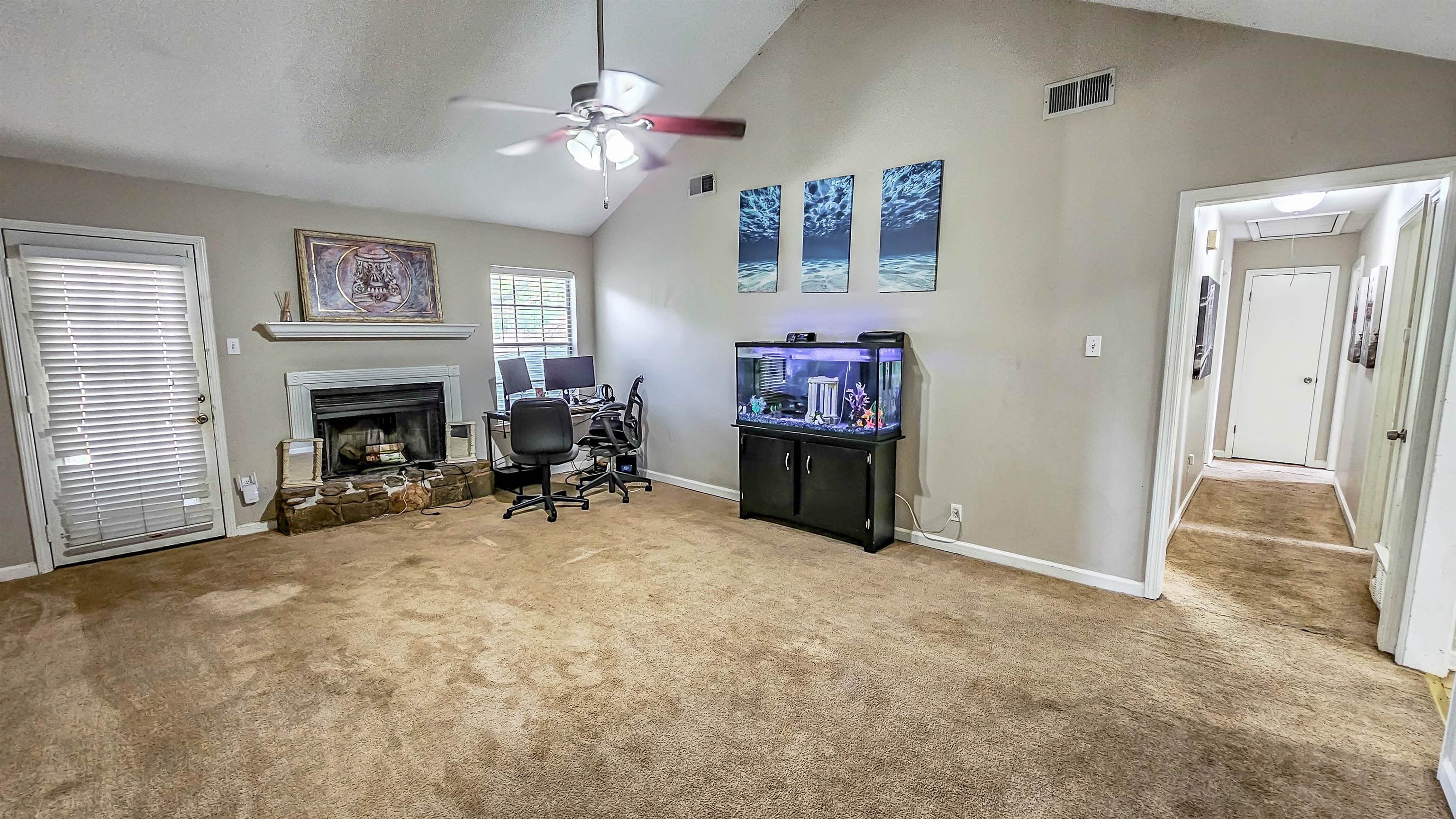 3735 Rippling Creek Cove Memphis, TN 38135 - Photo 8 of 28 a view of a livingroom with a fireplace a chandelier and windows