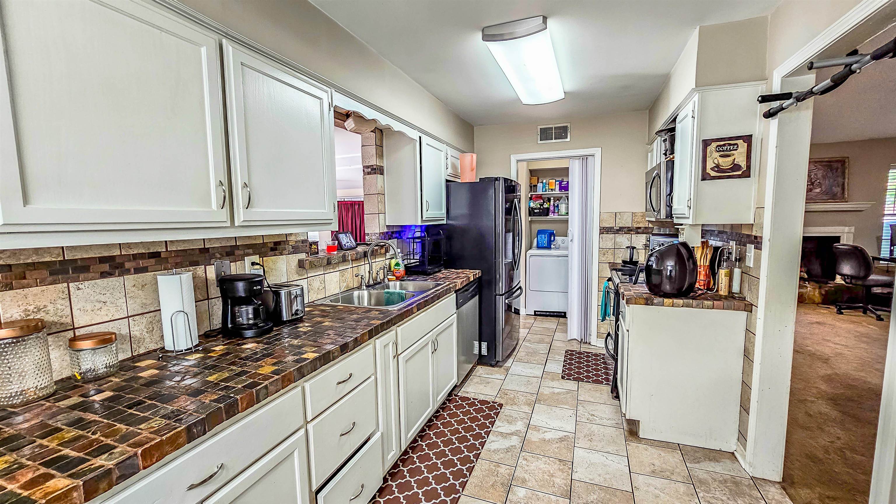 3735 Rippling Creek Cove Memphis, TN 38135 - Photo 10 of 28 a kitchen with stainless steel appliances granite countertop a refrigerator and a stove