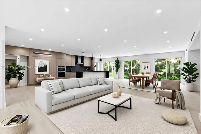 a living room with furniture kitchen and a large window