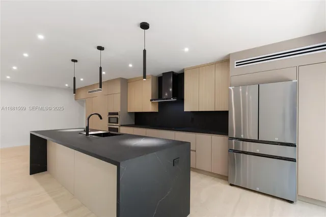 a kitchen with kitchen island a counter top space appliances and cabinets