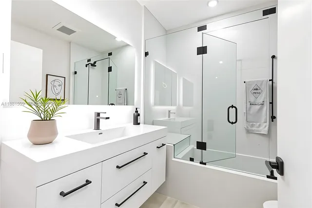 a bathroom with a sink toilet and shower