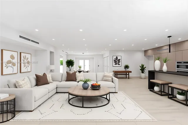a living room with furniture and a view of kitchen