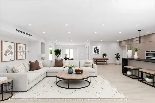 a living room with furniture and a view of kitchen