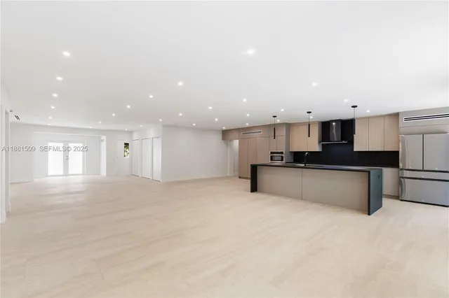 a view of kitchen with refrigerator and a sink