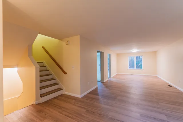 a view of a room with wooden floor and stairs