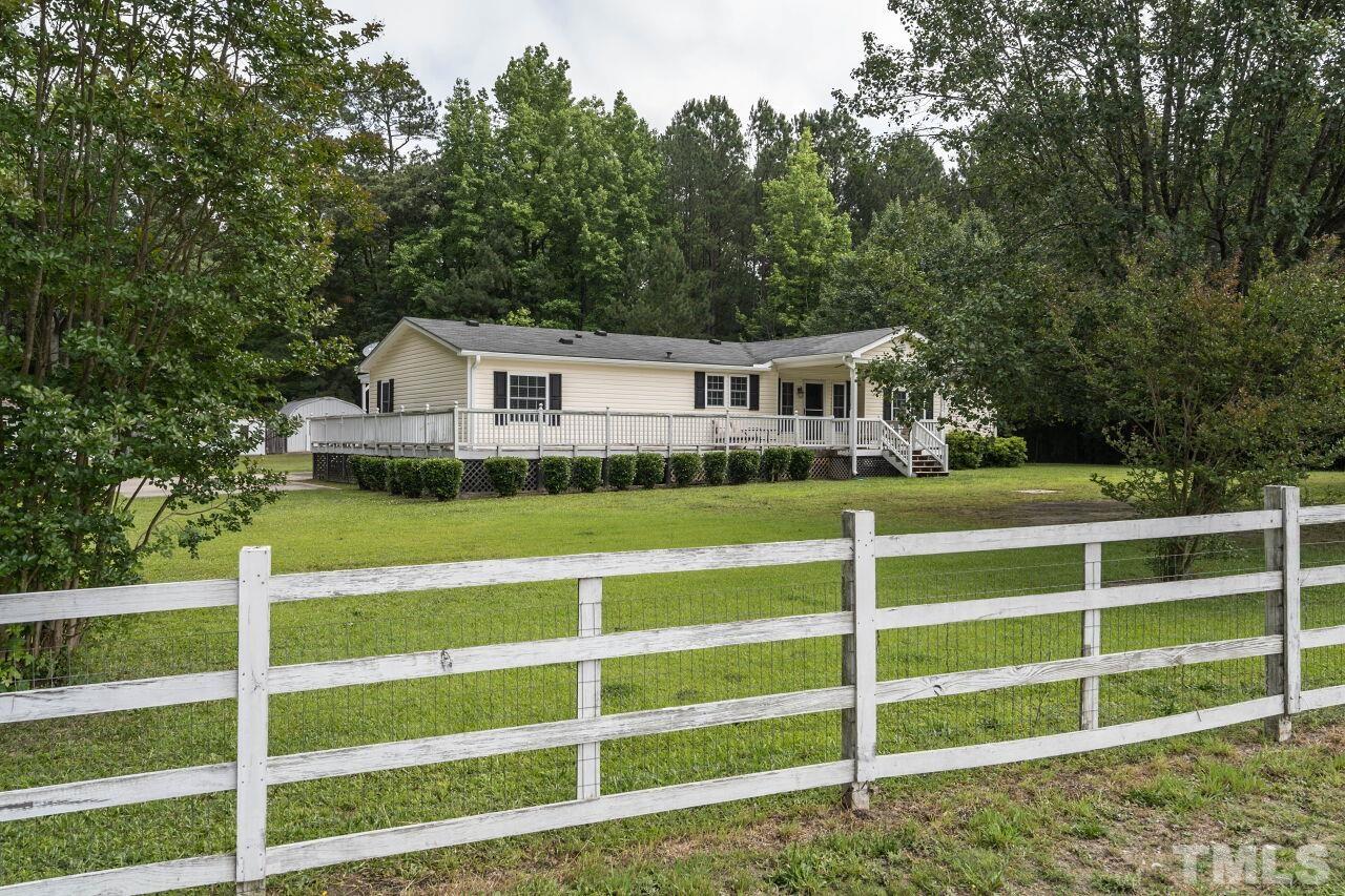 7409 Sidecreek Drive Raleigh, NC 27610 - Photo 29 of 29 a view of a house with a big yard and large trees